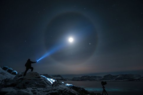 shining-flashlight-onto-moon-at-night